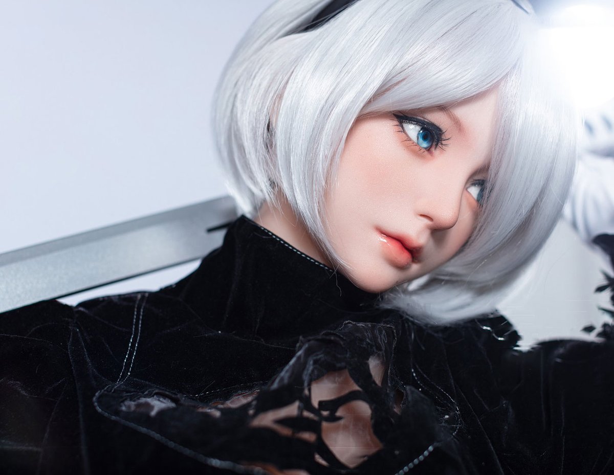 Profile of the silicone-head 2B doll against a grey studio background