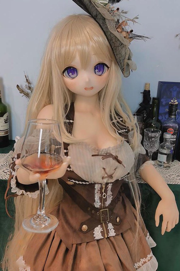 Abbey anime sex doll with PVC head seated with a wine glass in a tavern costume