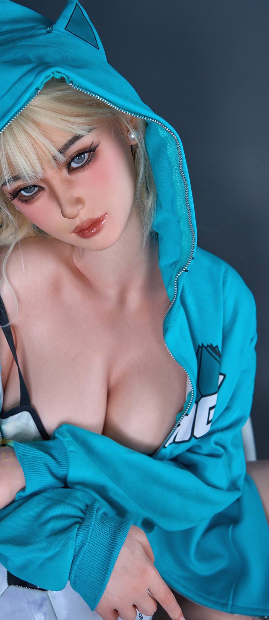Akari, a 161 cm Asian silicone doll in a cat-ear hood holding a football