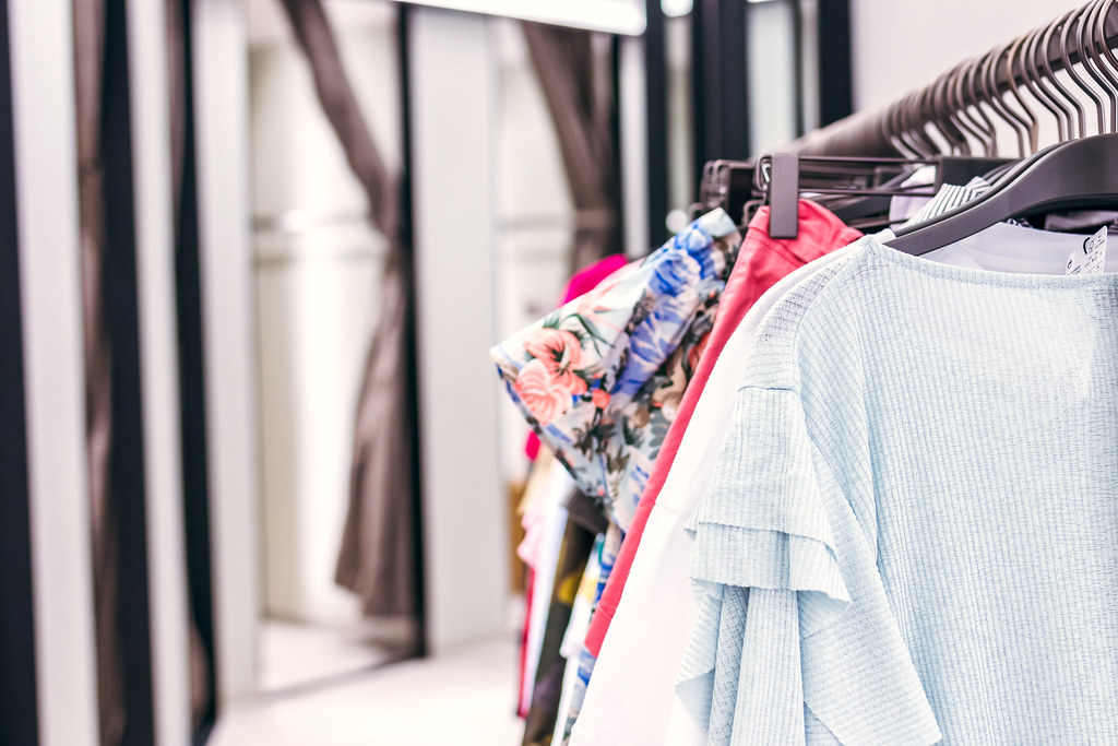 Clothing rail with hangers in a bright boutique