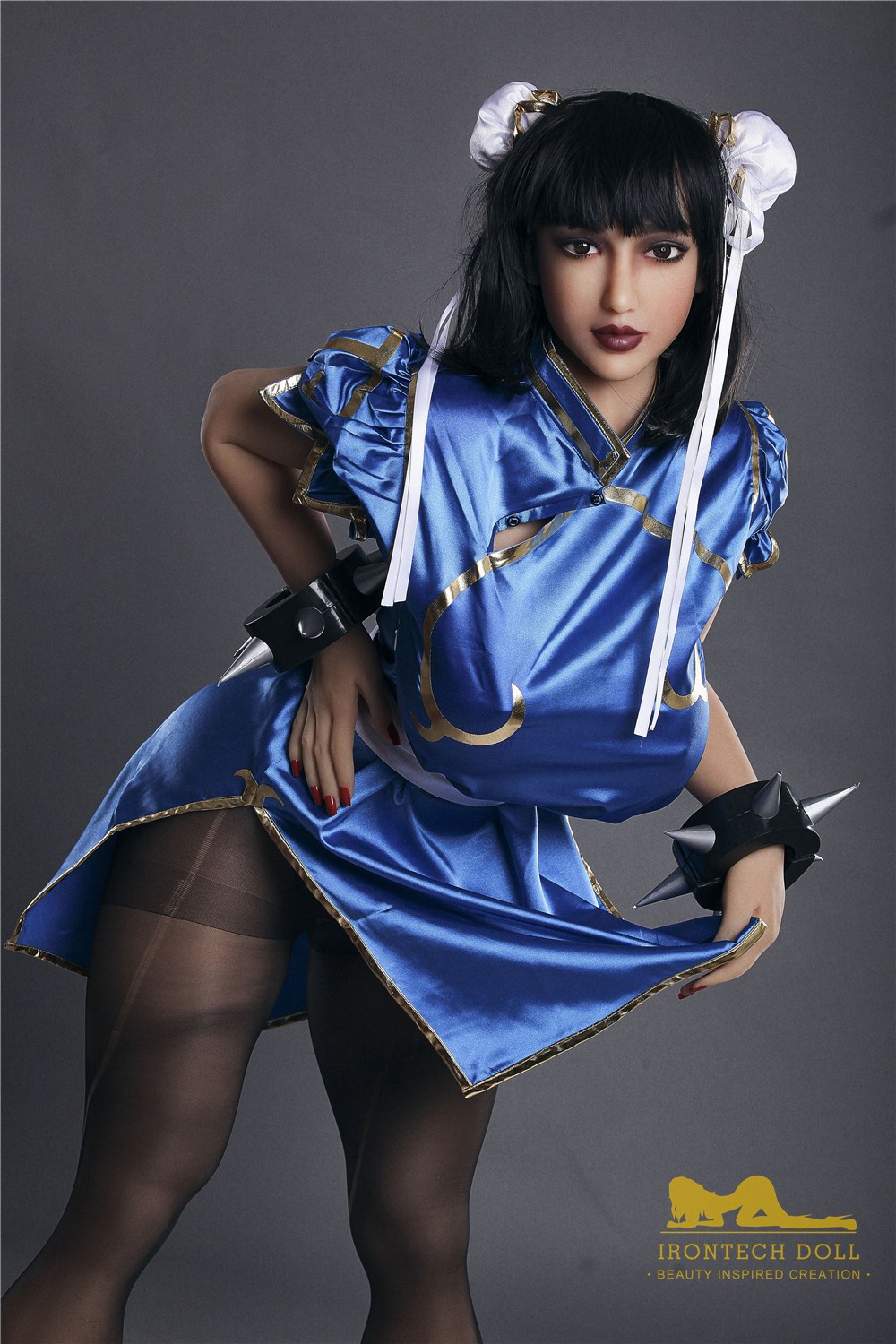 Emilia, a 158 cm cosplay TPE sex doll in a blue satin fighting dress with studded cuffs and boots