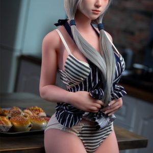 Emma, a 154 cm hybrid sex doll with a silicone head, in an apron in a kitchen