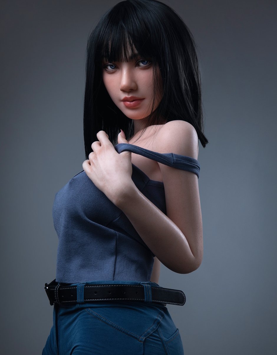 Magnolia, a 153 cm silicone doll pulling her tank strap in a studio