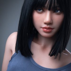 Magnolia, a 153 cm silicone sex doll with a black bob, in a gray tank top studio portrait