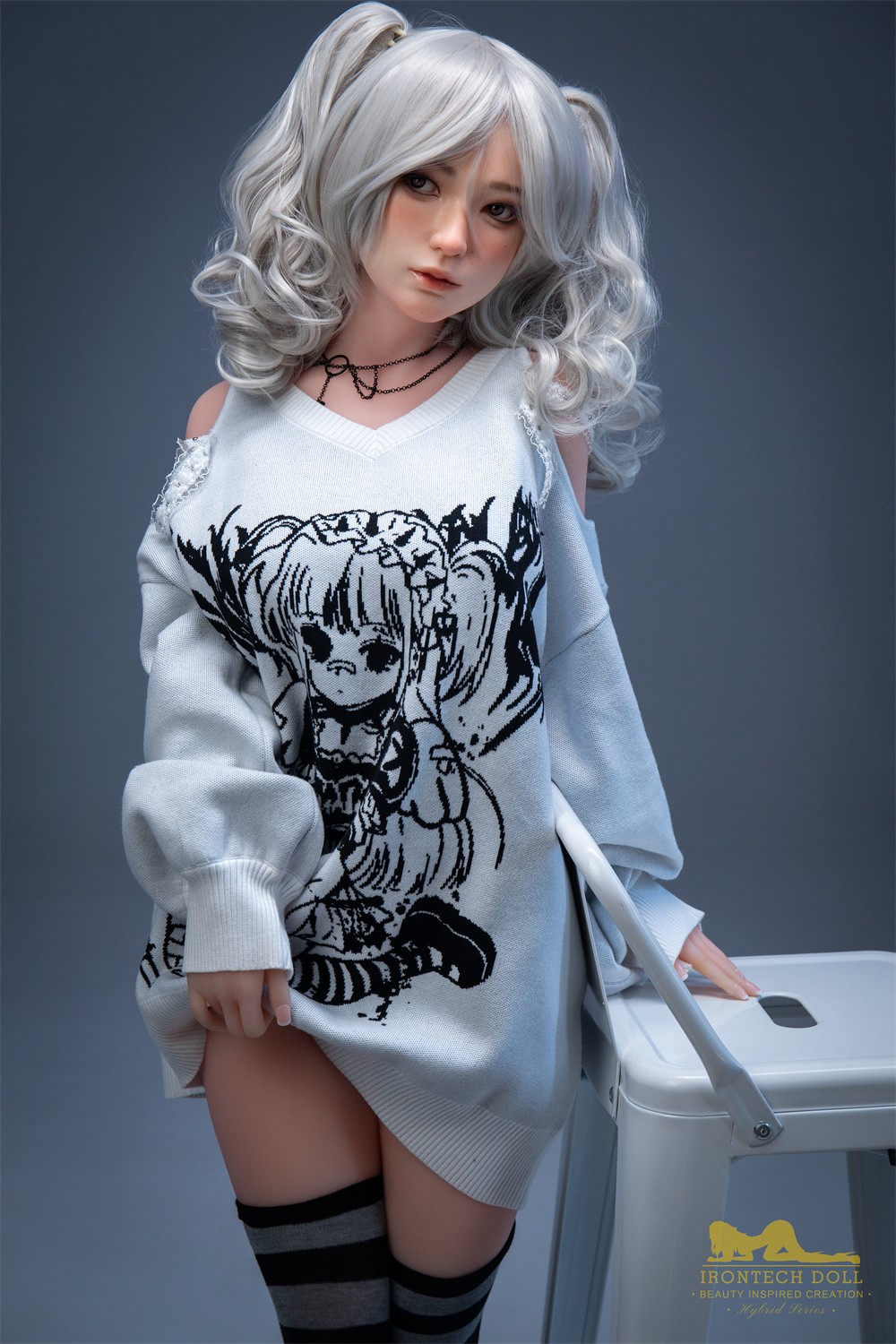 Olivia, a 154 cm hybrid sex doll leaning at a white stool