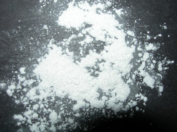 White talcum powder scattered on a dark surface