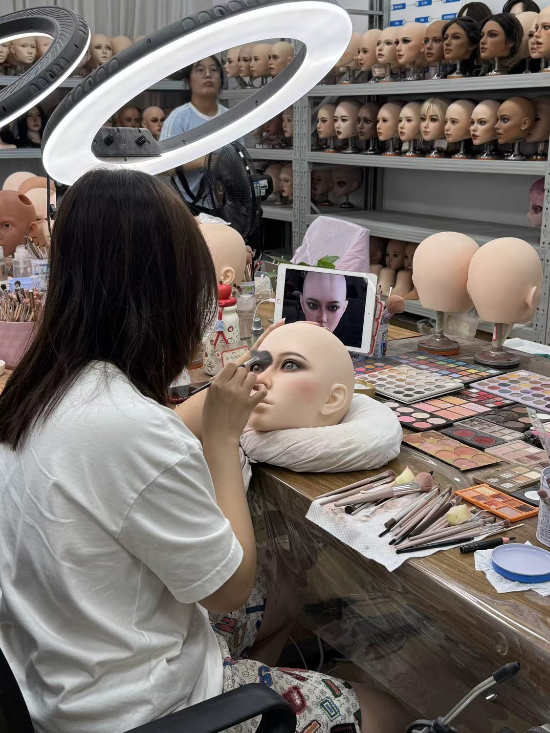 Make-up bench at the sex doll workshop with heads waiting for face work